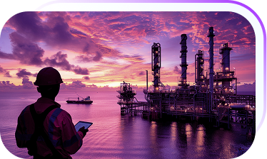 Engineer overlooking refinery with oil towers at sunset